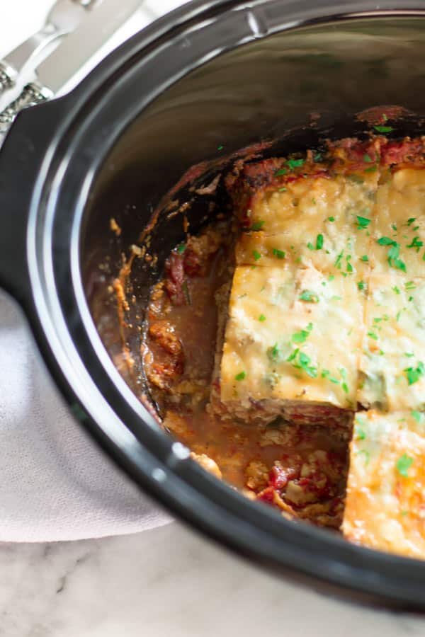 Slow Cooker Zucchini Lasagna - This lasagna is going to become your favourite lasagna recipe not only because I used zucchini instead of noodles, but also made in the slow cooker. Slices of out of a slow cooker zucchini lasagna.