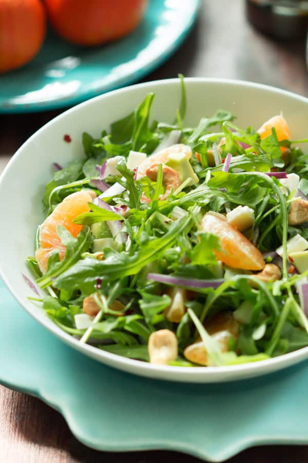 Clementine arugula salad is made epic with homemade clementine dressing. This salad is so bright and fresh, you might even be glad it’s winter – clementine’s favorite season!