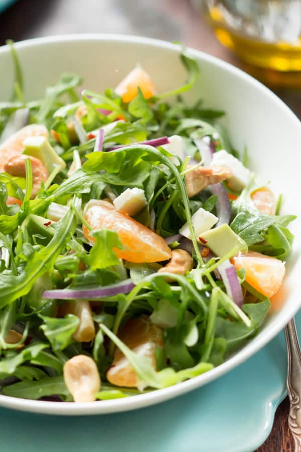 Clementine arugula salad is made epic with homemade clementine dressing. This salad is so bright and fresh, you might even be glad it’s winter – clementine’s favorite season!