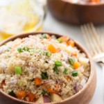 Close up of a couscous salad on a wooden bowl.