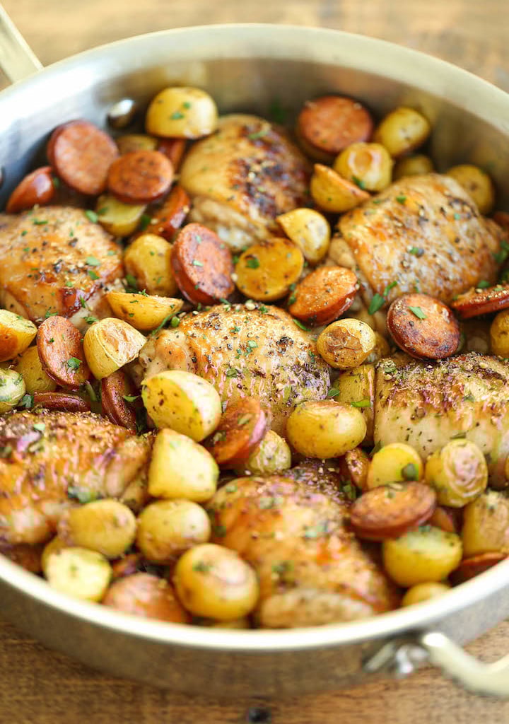 One Pan Spanish Chicken with potatoes and Andouille sausage in a skillet.