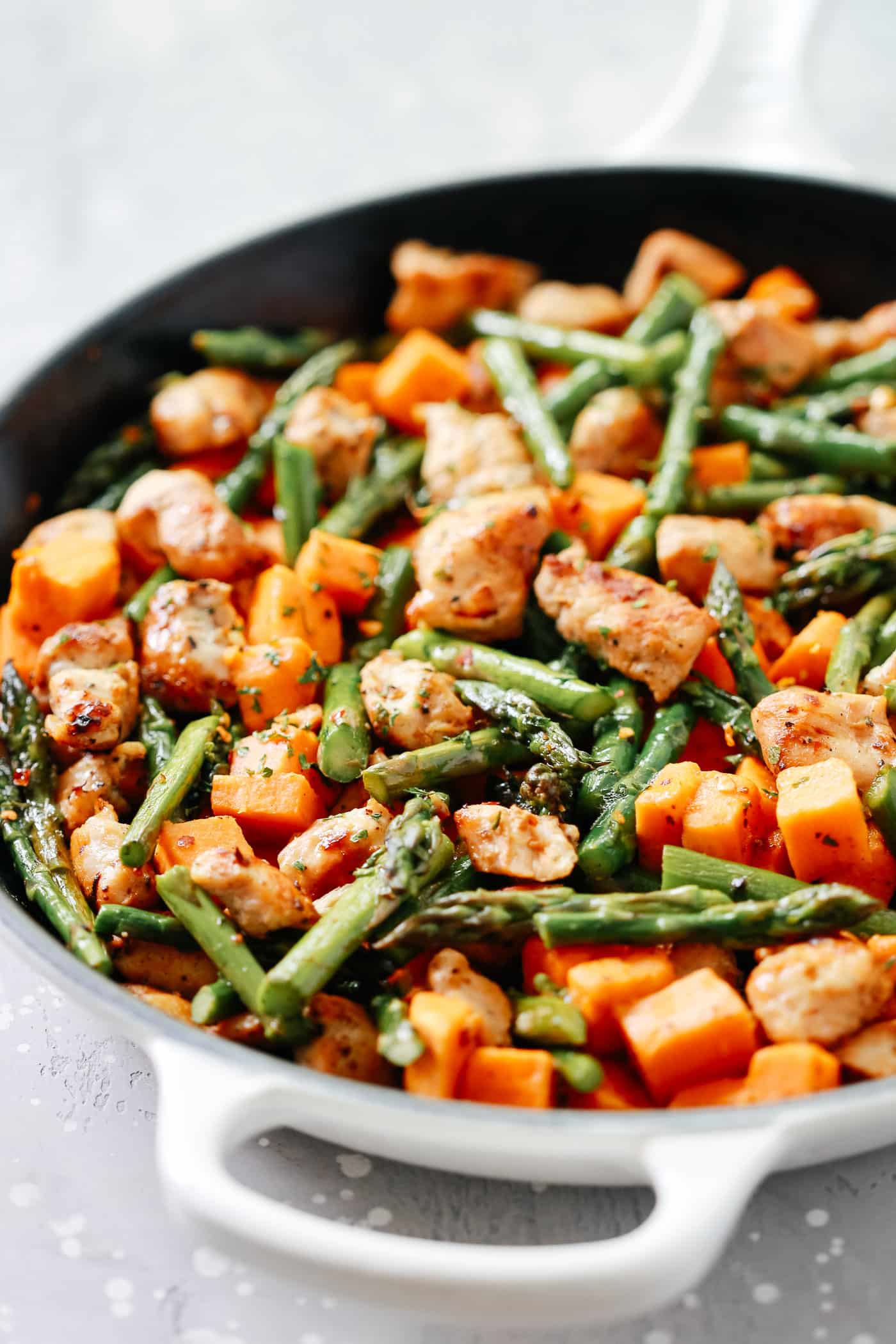 chicken and asparagus in a cast iron skillet