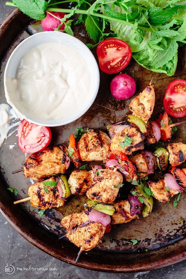 Overhead view of Mediterranean Grilled Chicken Kabobs on a baking sheet