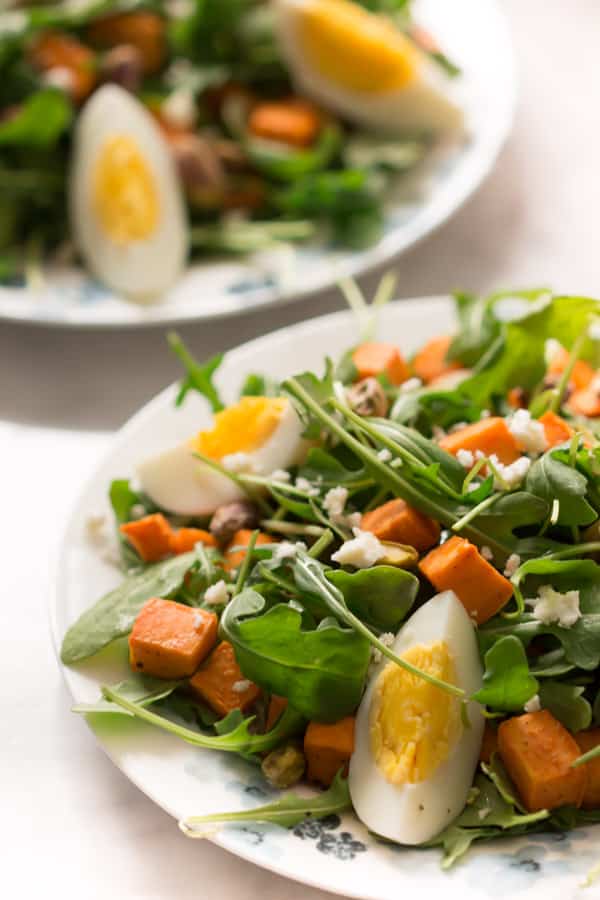 sweet-potato-arugula-salad - This Sweet Potato Arugula Salad is packed with pistachios, sweet potato, feta cheese and a delicious honey Dijon vinaigrette that pairs deliciously with arugula.