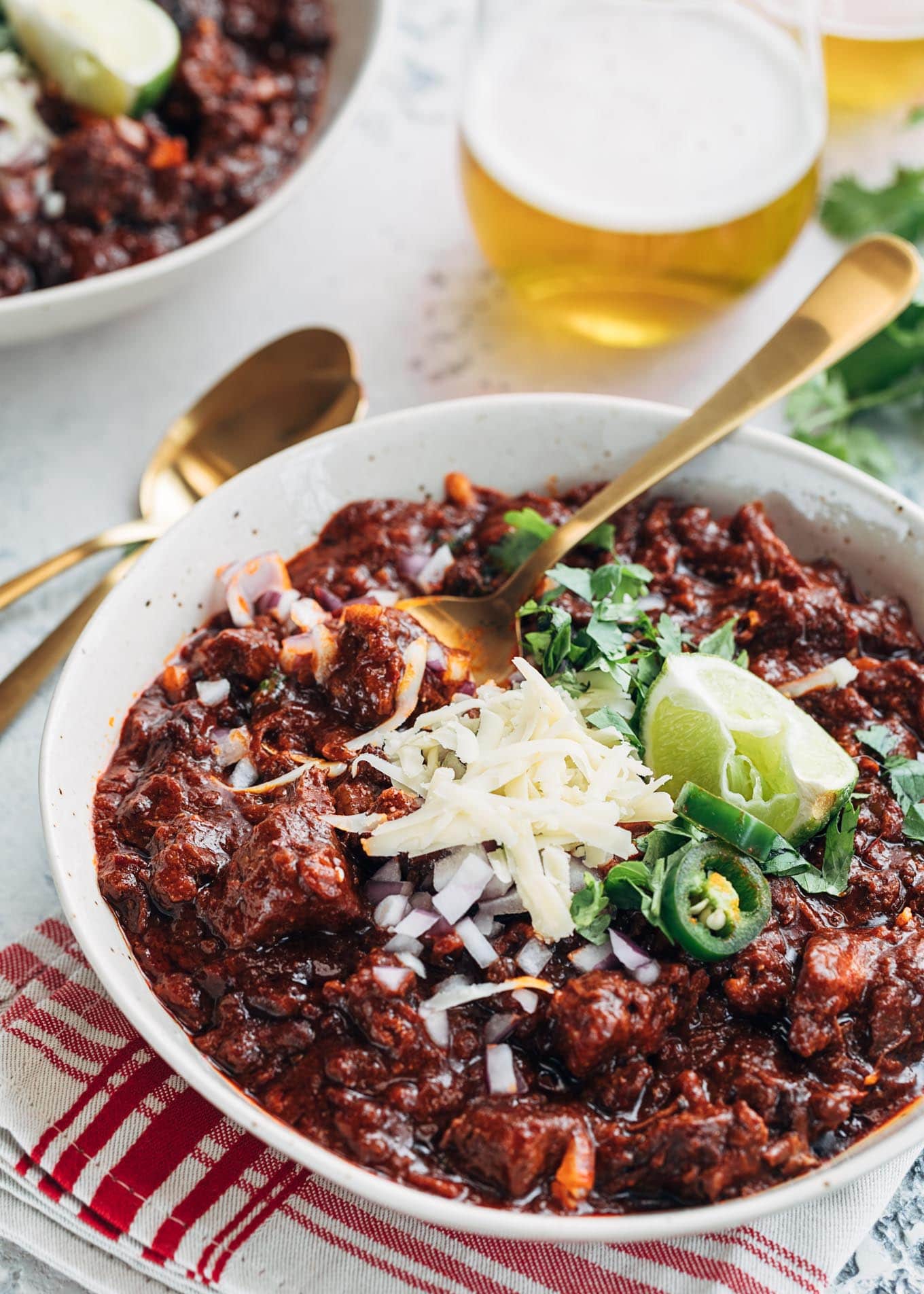 A close up of a white bowl of Texas style chili