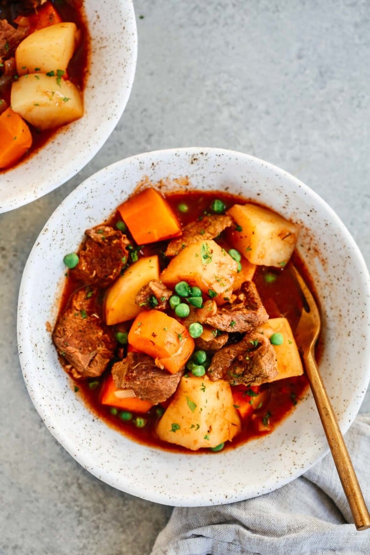 Healthy slow cooker beef stew inside of a white bowl.