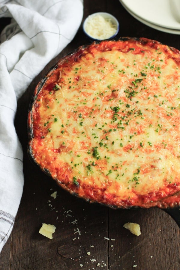 low-carb-zucchini-lasagna-skillet-This cheesy and saucy Low Carb Zucchini Lasagna Skillet is one-pan meal that has a delicious sauté mushroom filling, which brings this gluten-free lasagna to a new level on flavour. It’s also very simple to assemble in a skillet. overhead view of a cast iron skillet containing zucchini lasagna