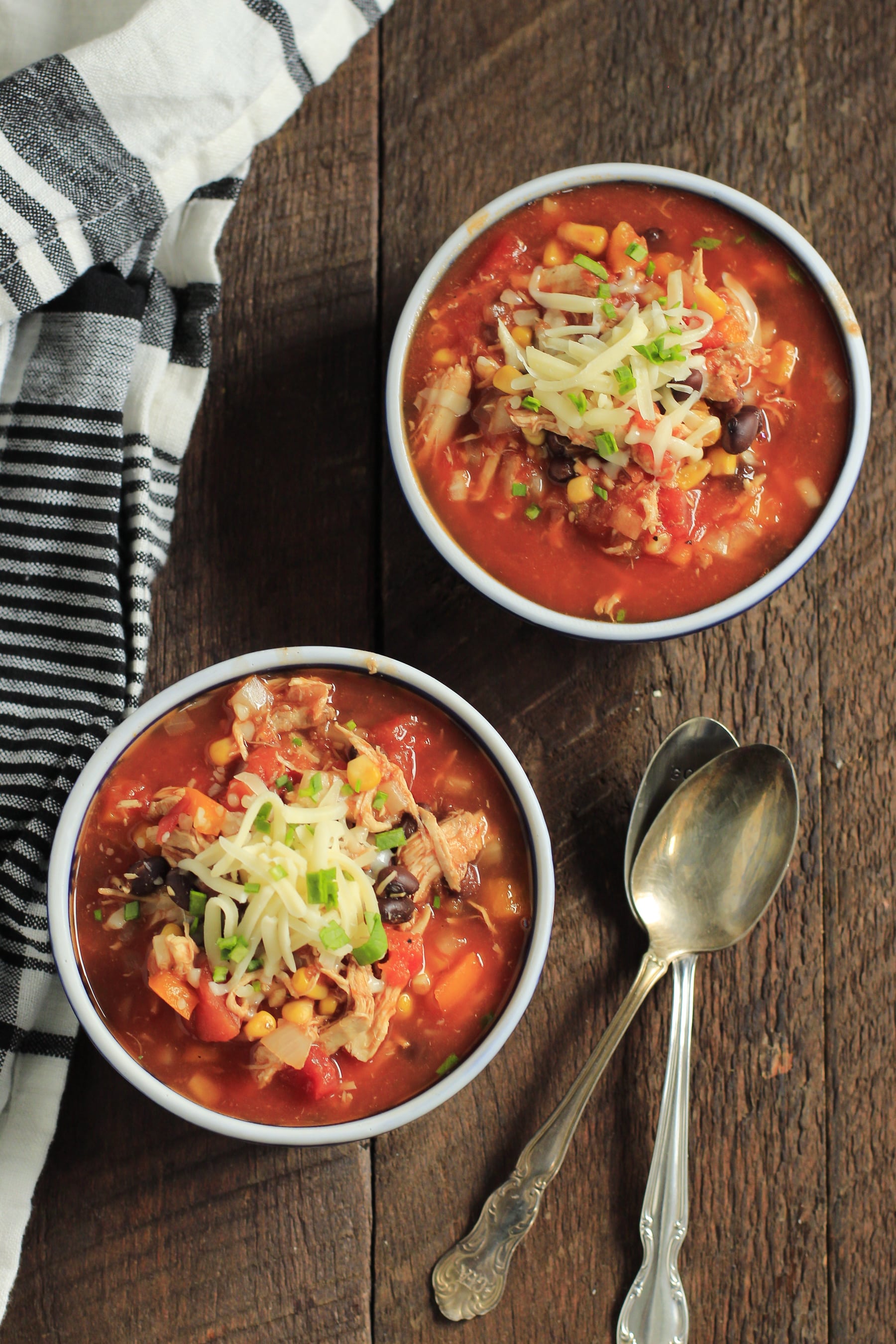 overhead view of two bowls containing slow cooker chicken chili