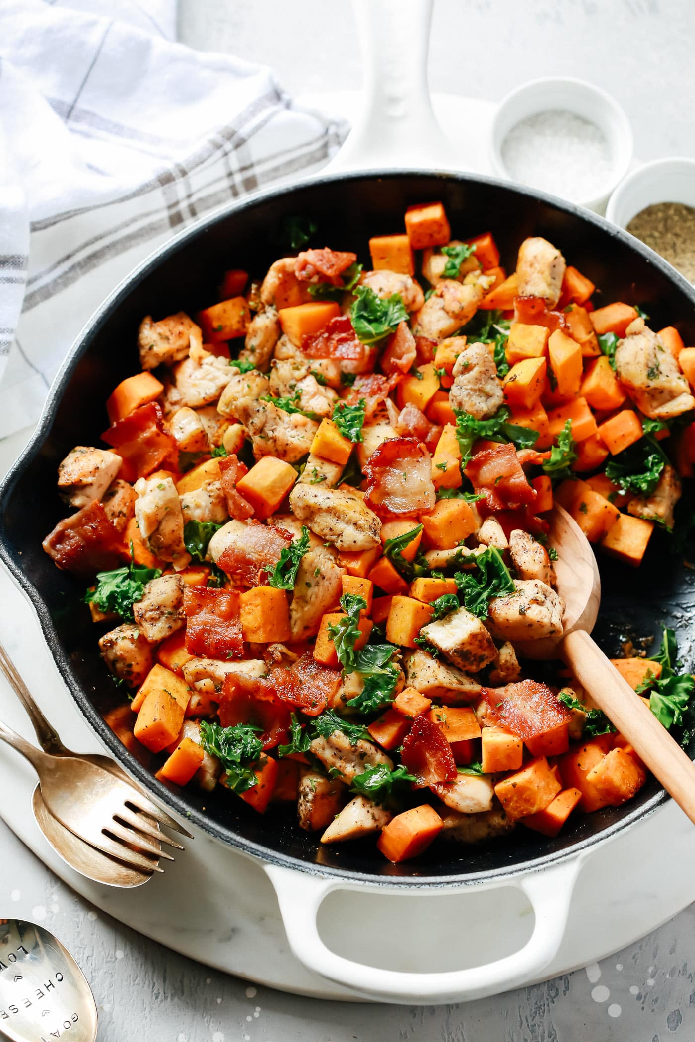 overhead view of a white skillet containing kale, chicken and sweet potato. gluten-free dinner recipes