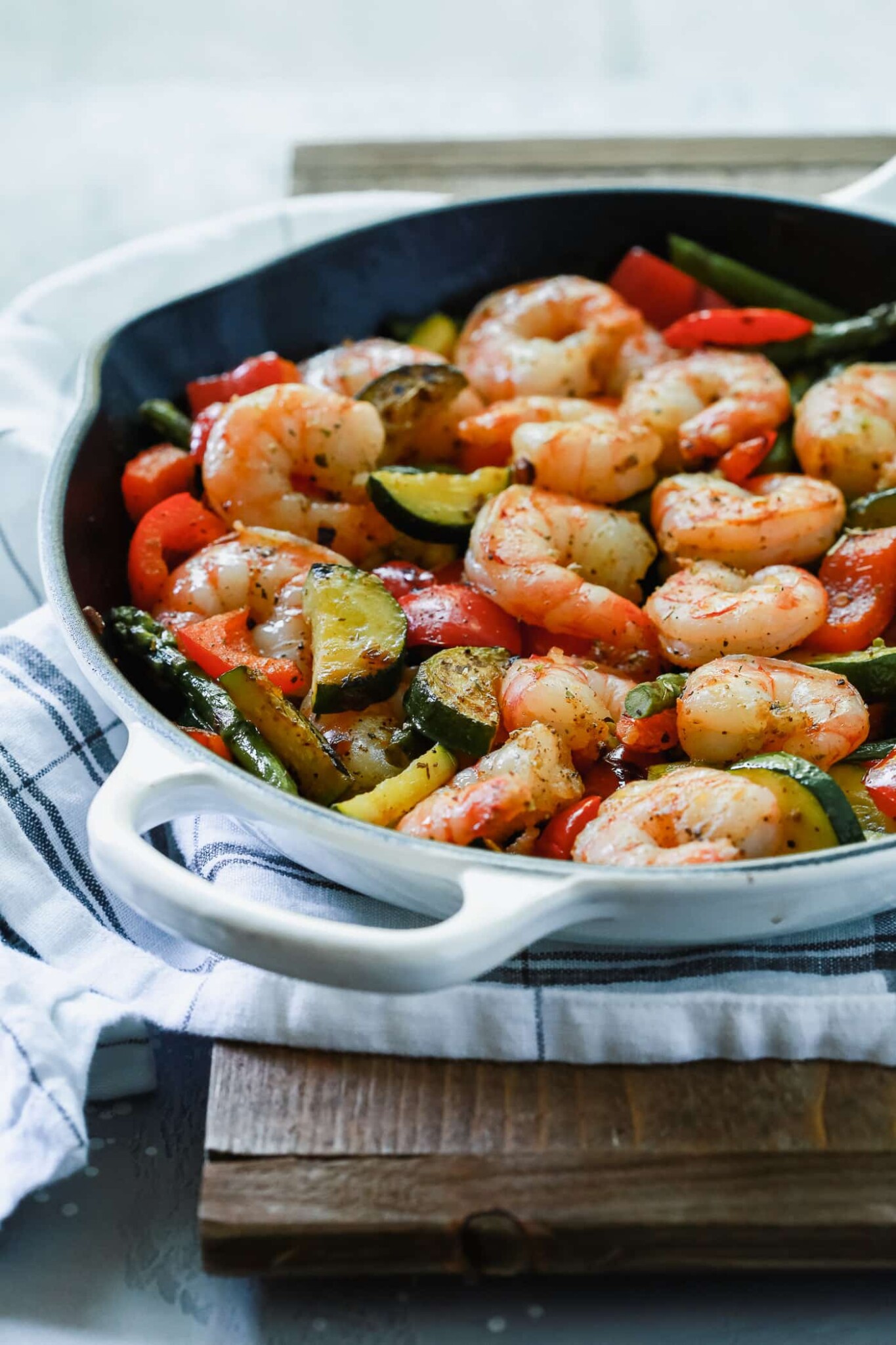 closeup of a white skillet containing shrimp and vegetables - gluten-free dinner recipes