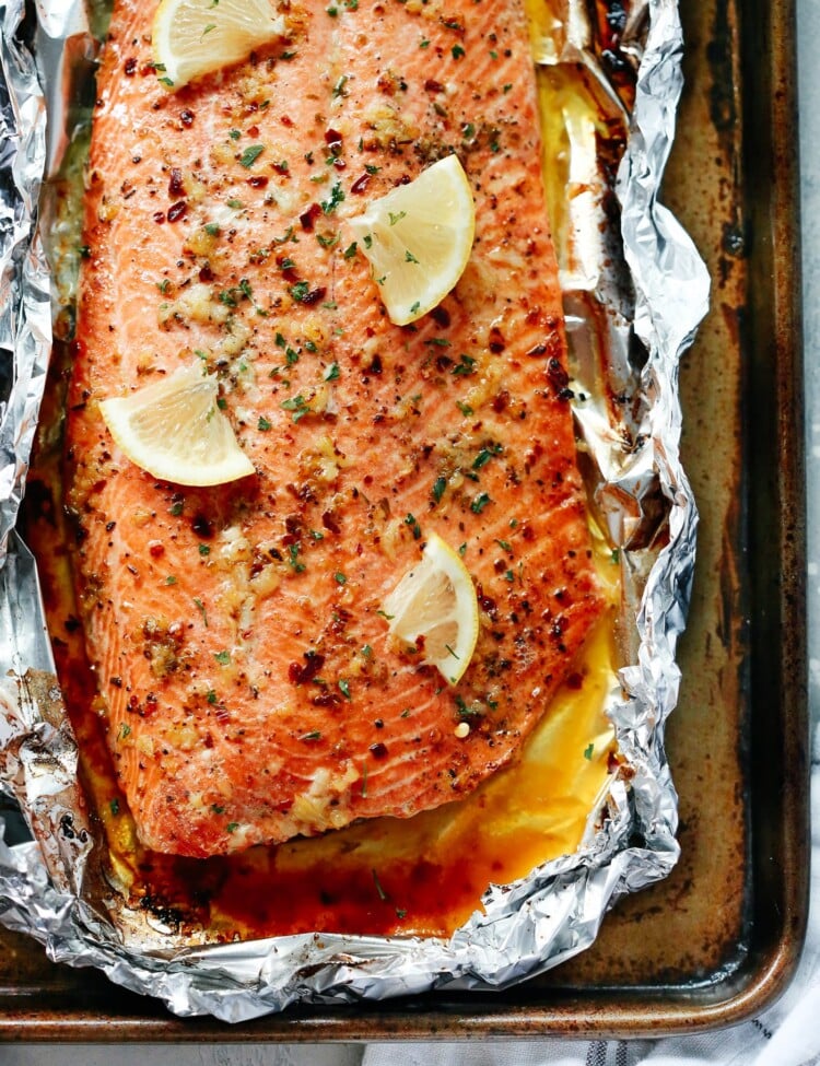 wild salmon fillet with lemon slices and garlic butter