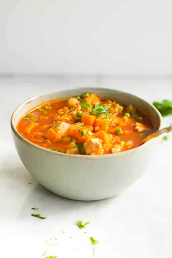 close up of a bowl containing sweet potato chicken soup