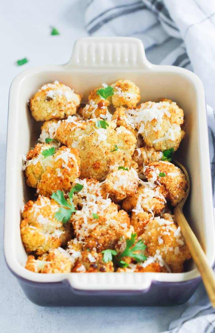 Overhead photo of garlic parmesan roasted cauliflower in a baking dish.