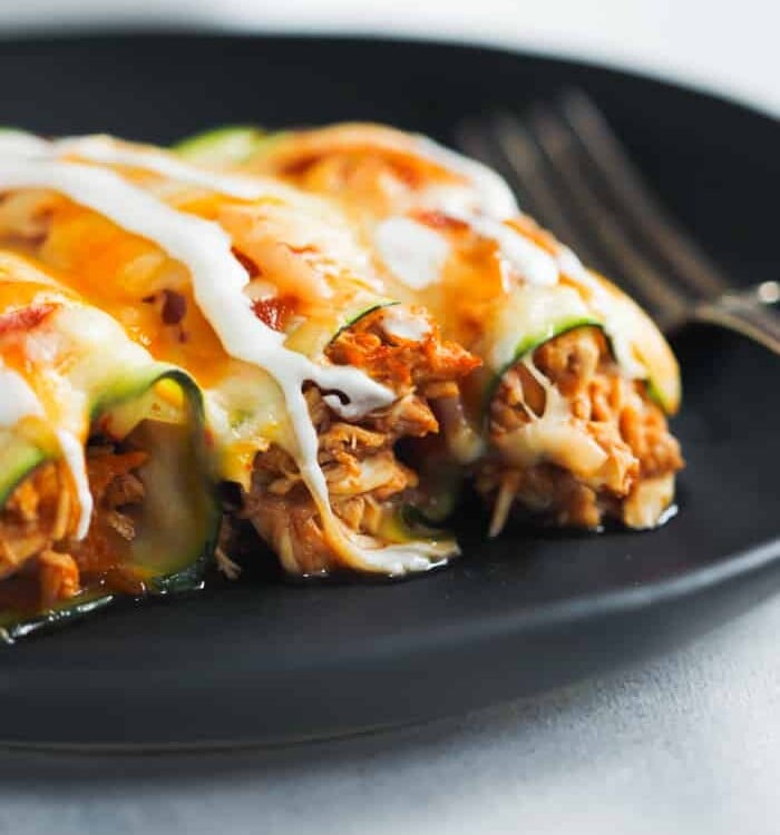 overhead view of Low-Carb Chicken Zucchini Enchilada in a black plate