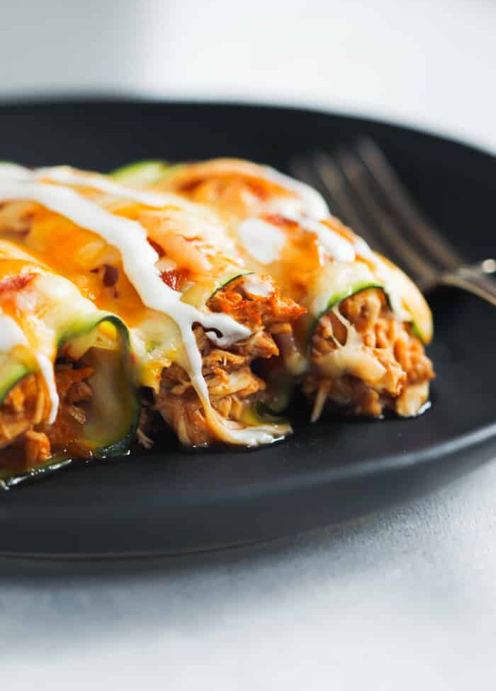 overhead view of Low-Carb Chicken Zucchini Enchilada in a black plate