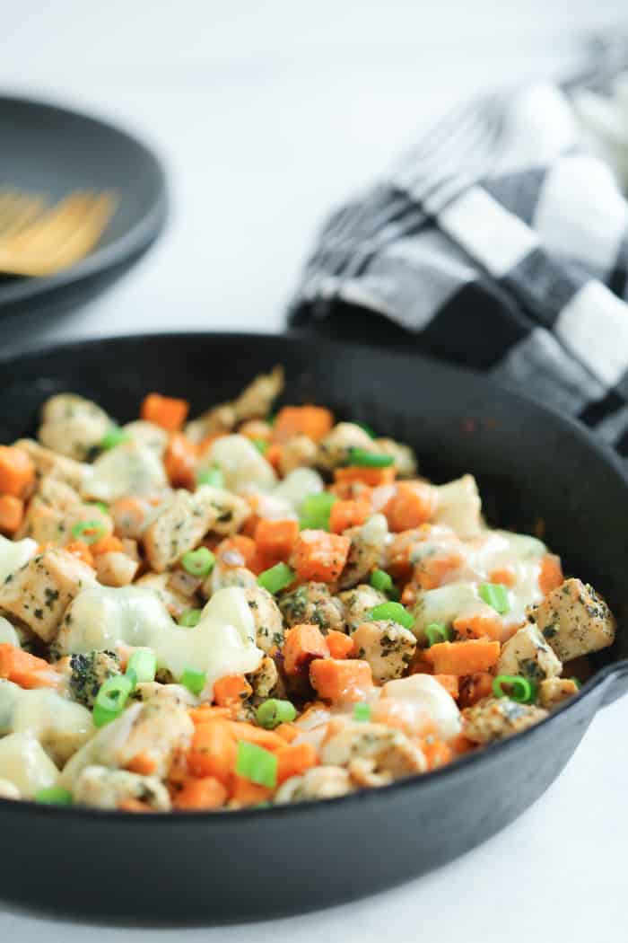 Closed up of a healthy skillet recipe called Pesto chicken. 