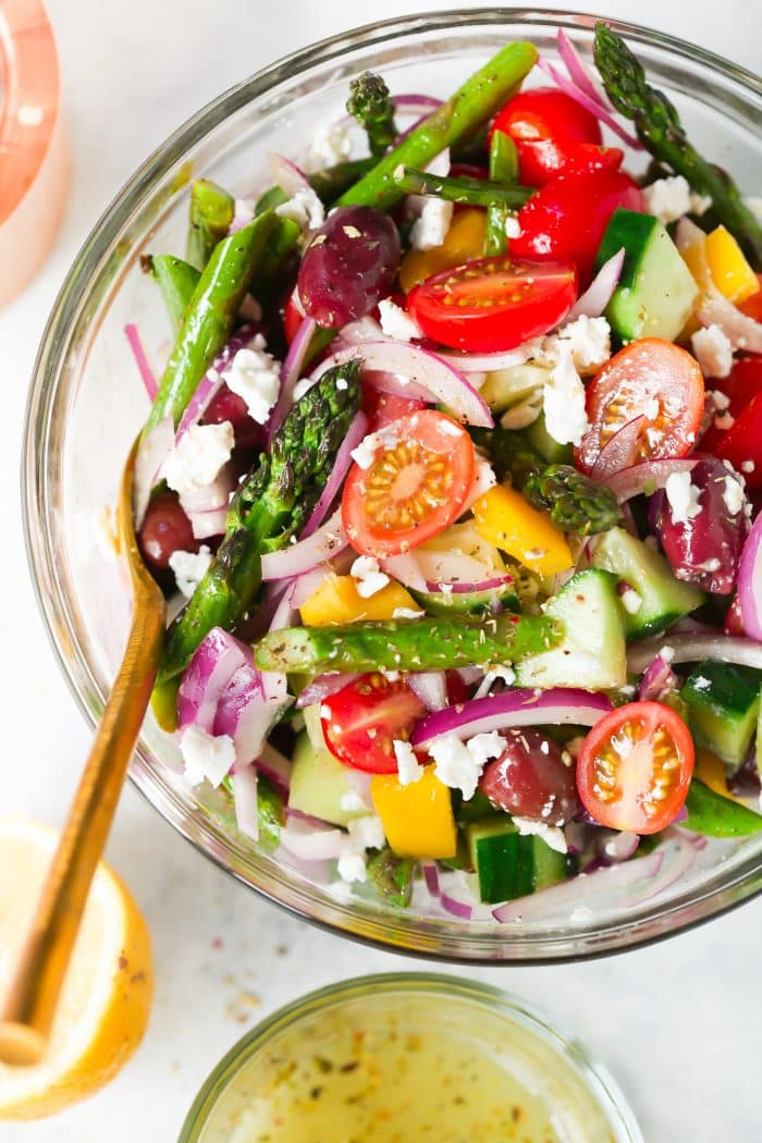 overhead view of asparagus salad in a glass bowl