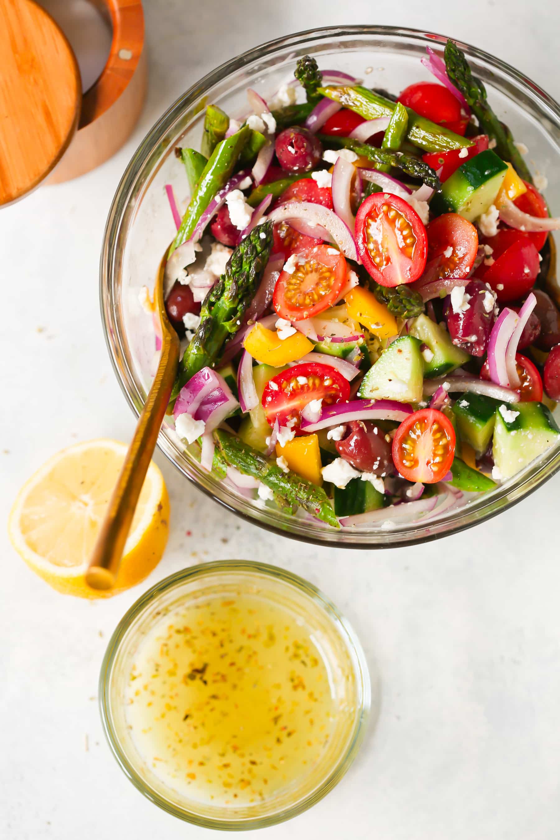 Asparagus Greek Chopped Salad - This Asparagus Greek Chopped Salad is made with roasted asparagus, cucumber, tomatoes, black olives, feta cheese and flavored with an easy lemon dressing.