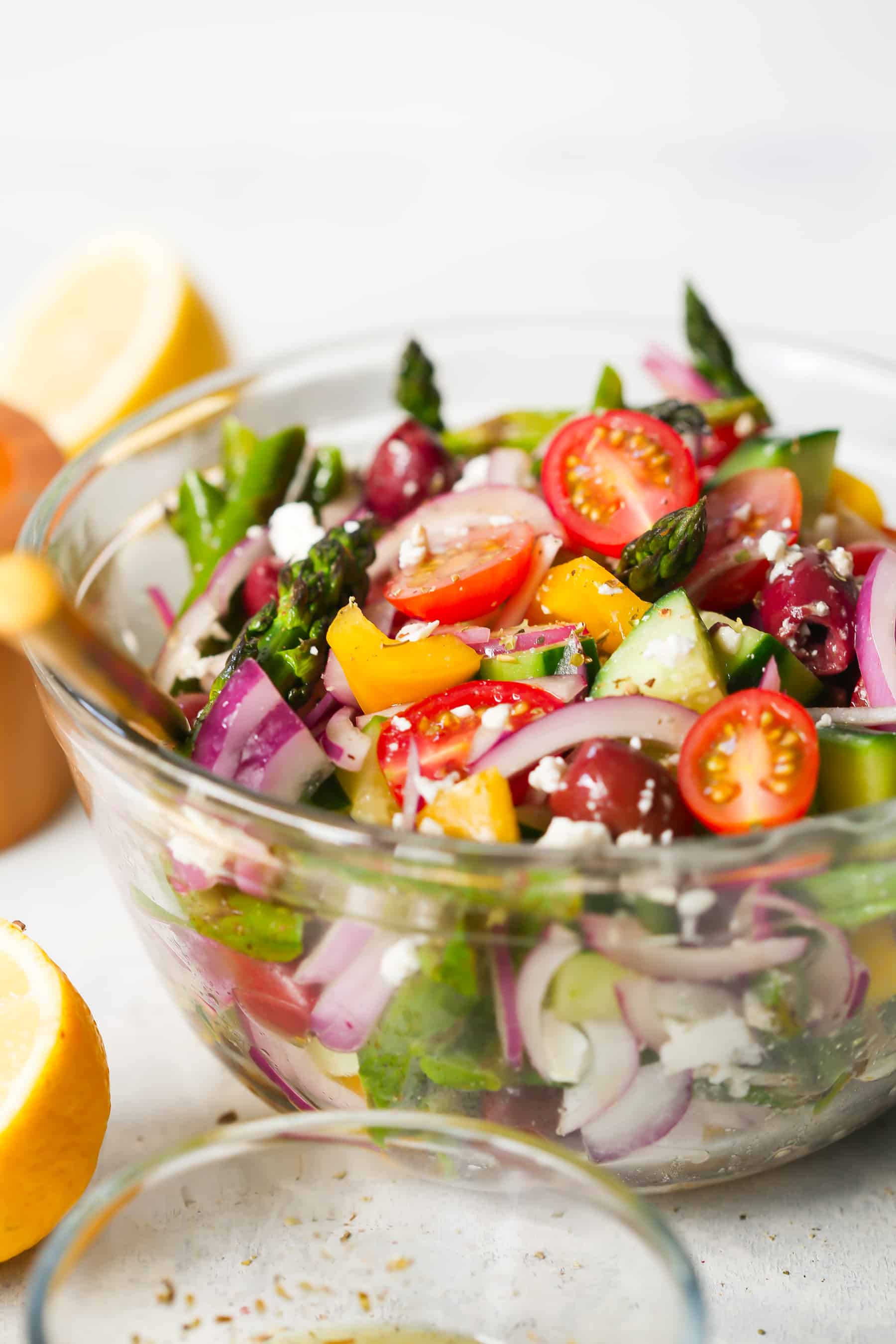 Asparagus Greek Chopped Salad - This Asparagus Greek Chopped Salad is made with roasted asparagus, cucumber, tomatoes, black olives, feta cheese and flavored with an easy lemon dressing.