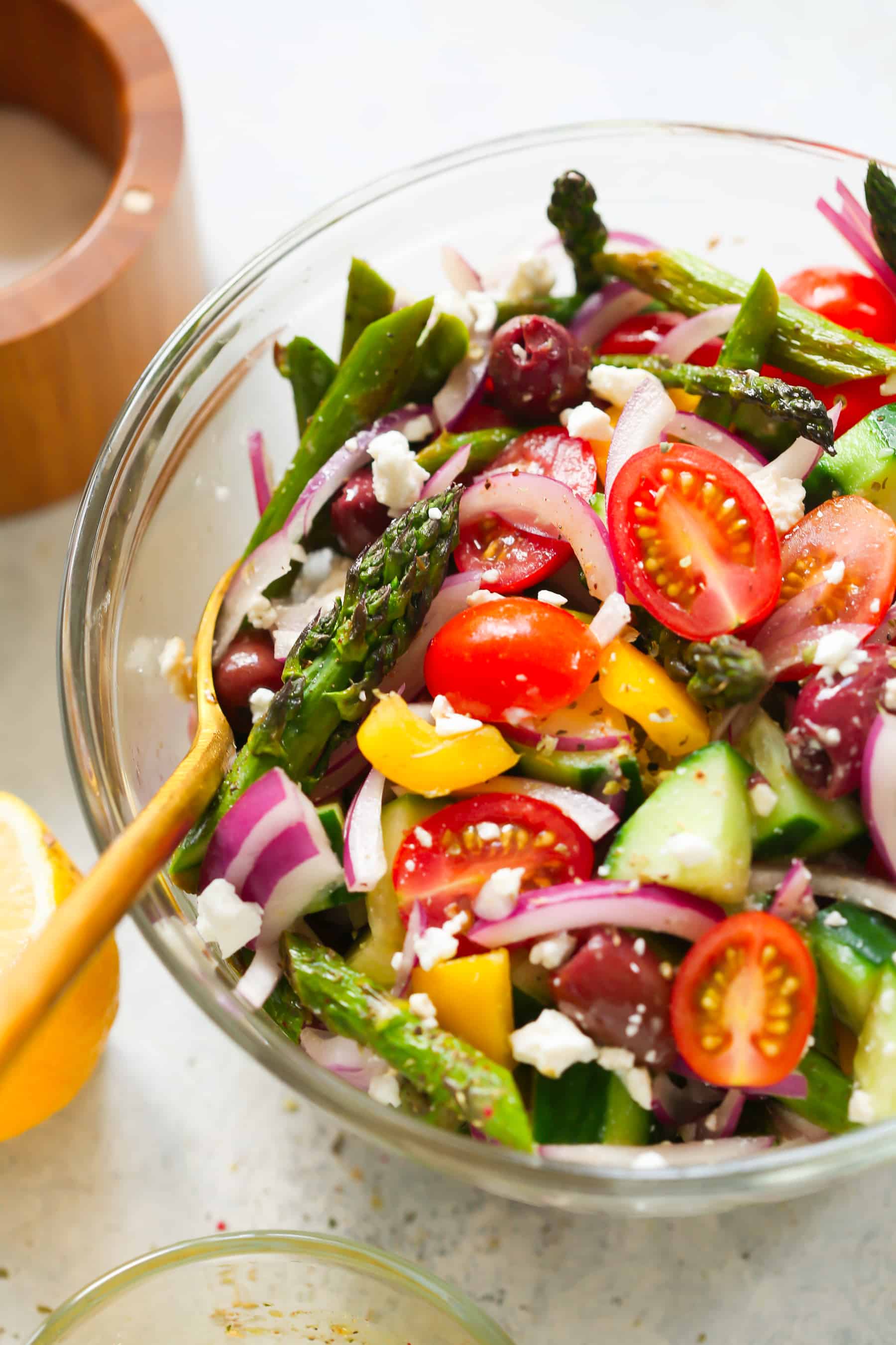 Asparagus Greek Chopped Salad - This Asparagus Greek Chopped Salad is made with roasted asparagus, cucumber, tomatoes, black olives, feta cheese and flavored with an easy lemon dressing.