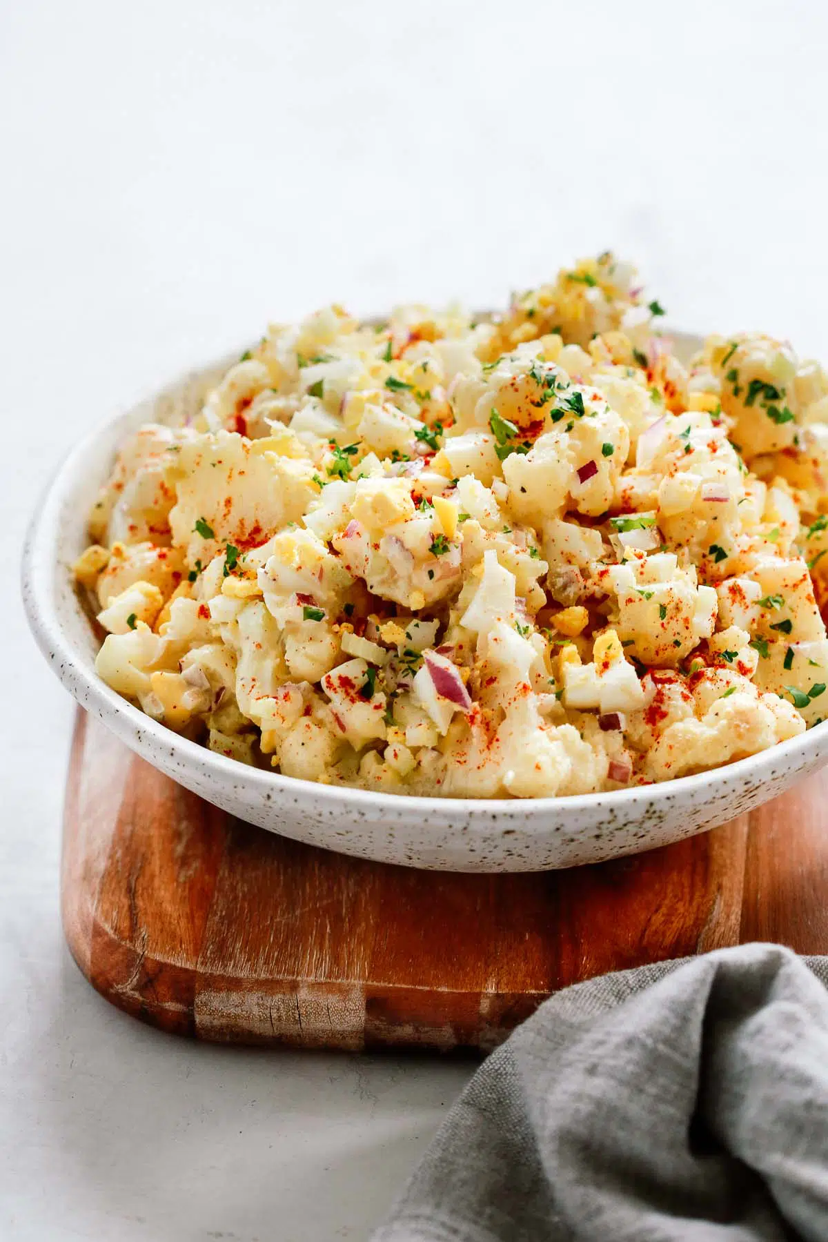 A white bowl with cauliflower potato salad.