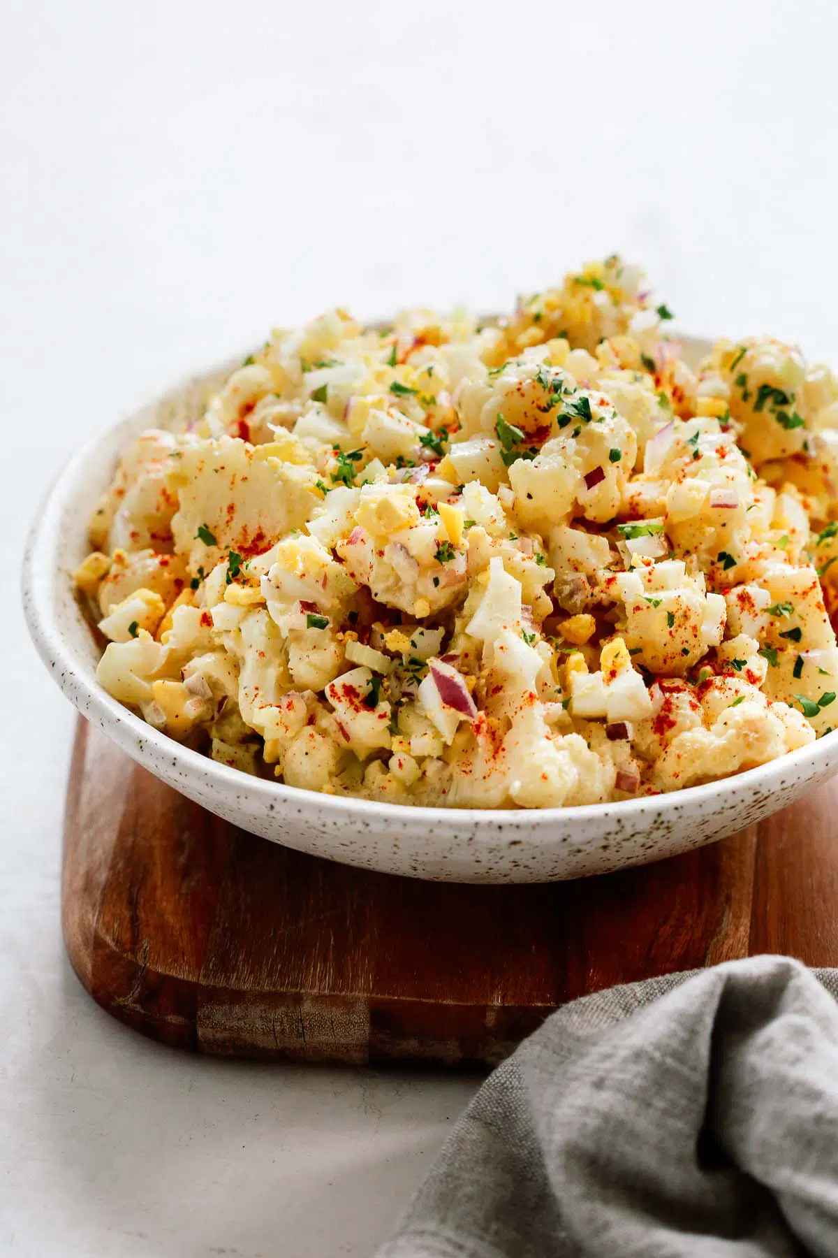 Overhead shot of cauliflower potato salad on grey background