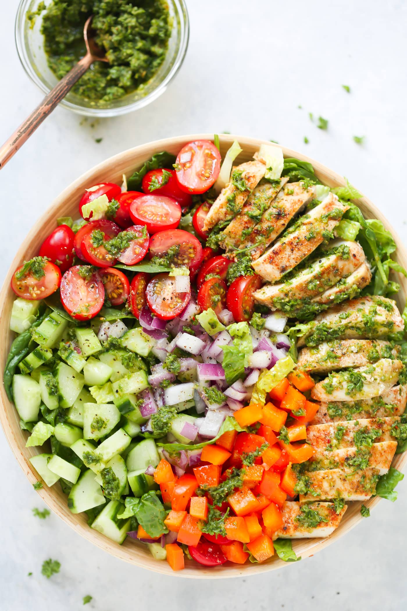 This fresh Chimichurri Chicken Chopped Salad is loaded with lettuces, cherry tomatoes, cucumber, bell pepper, red onions and grilled chicken. It's a complete meal to enjoy this summer!