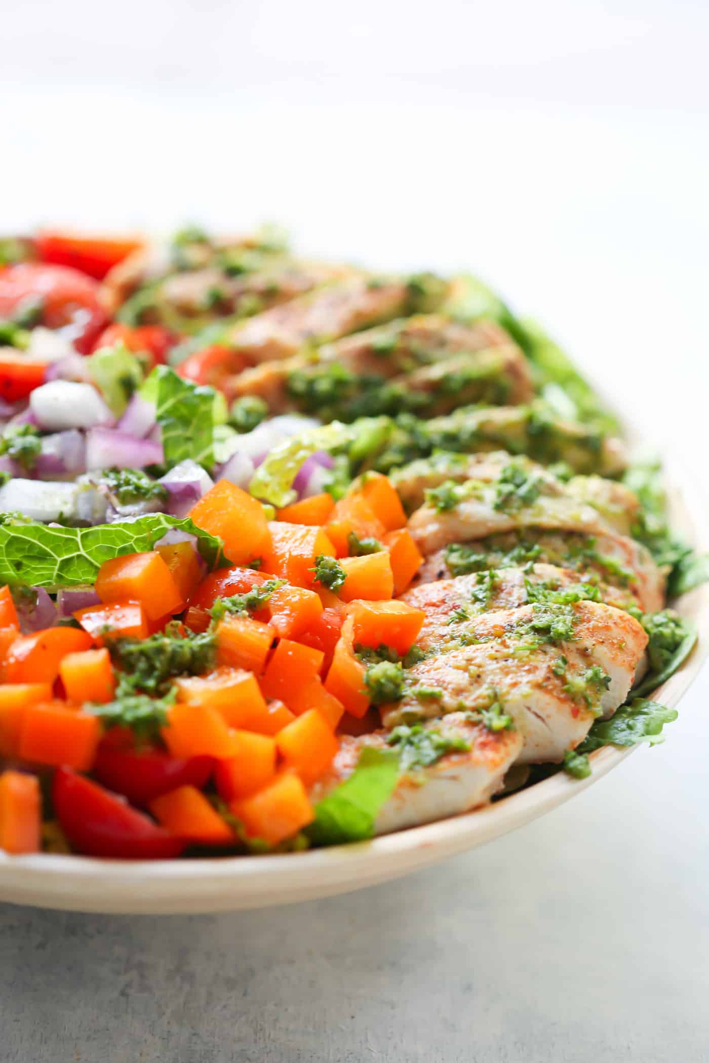 This fresh Chimichurri Chicken Chopped Salad is loaded with lettuces, cherry tomatoes, cucumber, bell pepper, red onions and grilled chicken. It's a complete meal to enjoy this summer!