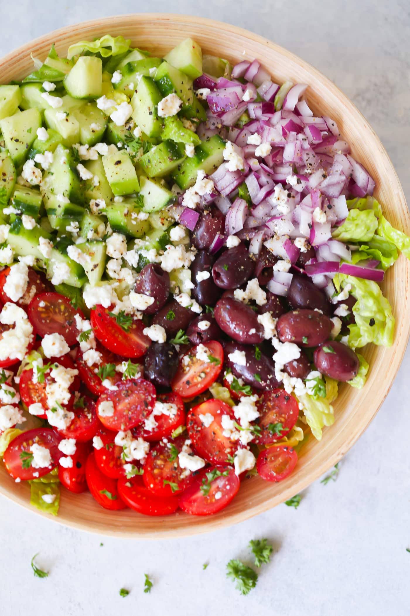 Easy Mediterranean Chopped Salad - Enjoy this Easy Mediterranean Chopped Salad made with red onions, black olives, lettuces, cucumber, cherry tomatoes, feta cheese and light lemon dressing! 