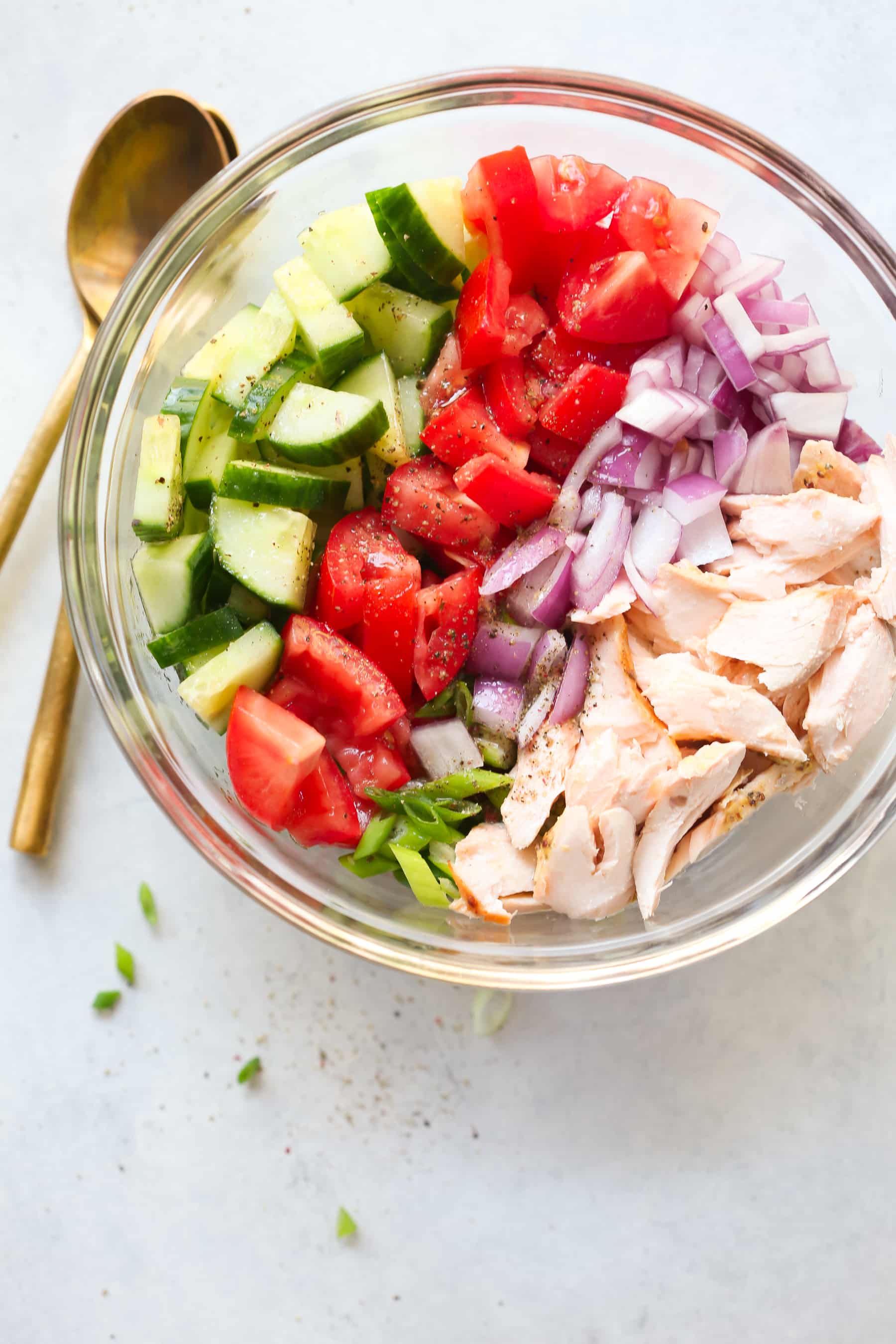 overhead view of salmon salad inside of a glass bowl