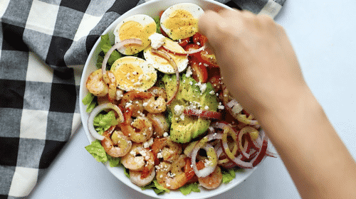 overhead view of shrimp avocado tomato salad in a bowl