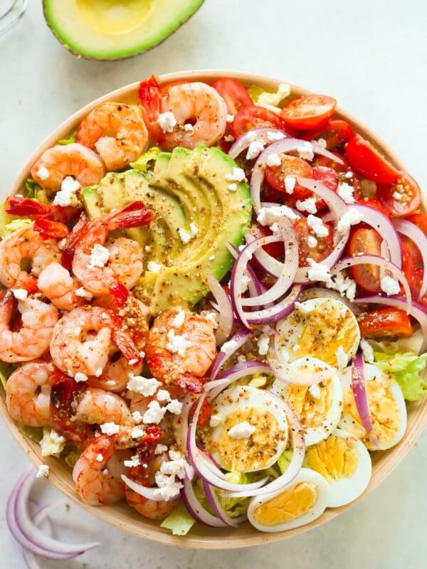 overhead view of a bowl containing shrimp avocado tomato salad.