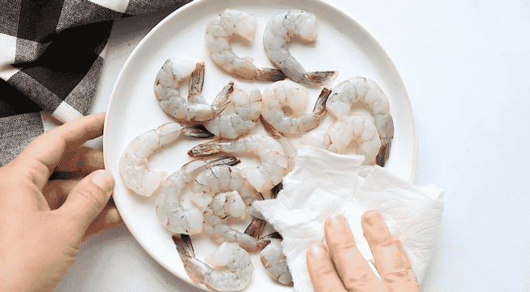 raw shrimp in a white plate