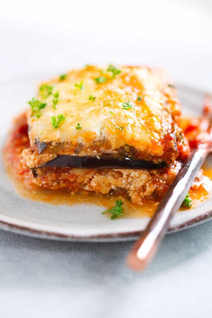 A piece of eggplant lasagna on a white plate. 