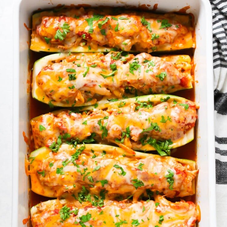 overhead view of zucchini boats in a white casserole