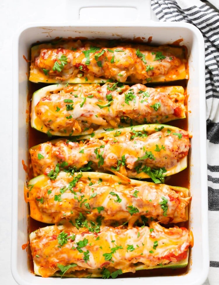 overhead view of zucchini boats in a white casserole