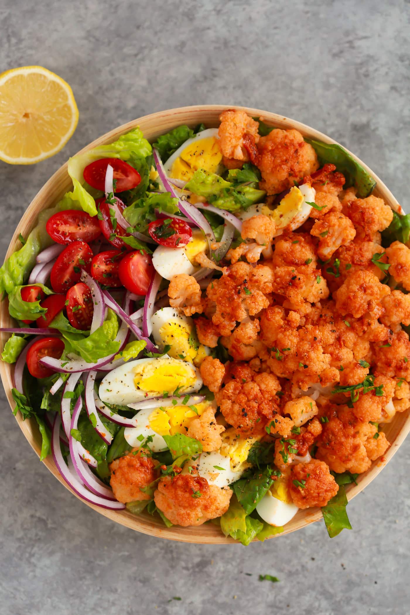 Overhead photo of a bowl of sun dried tomato pesto cauliflower salad.
