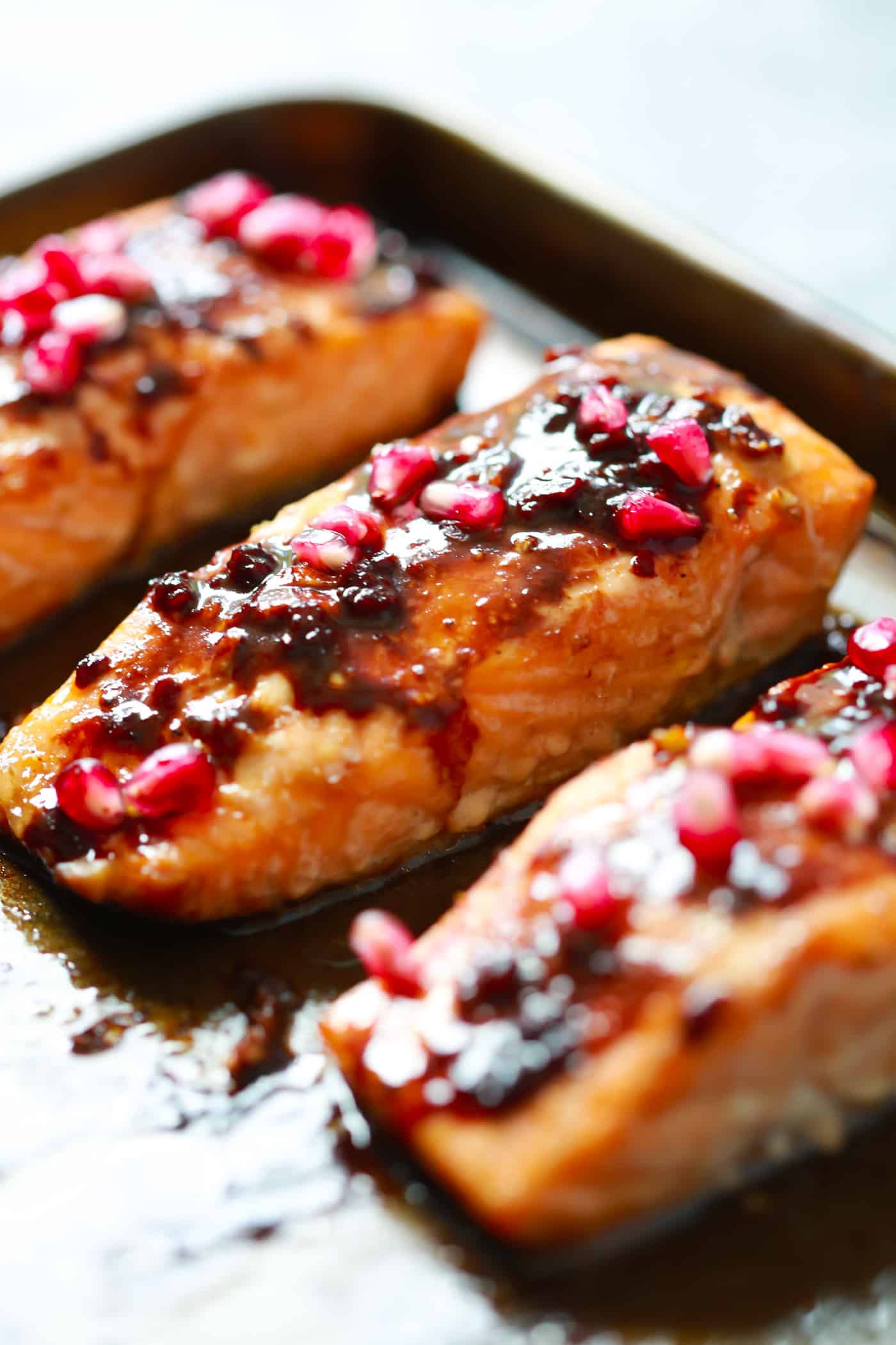 close up of 3 salmon fillet in a baking sheet