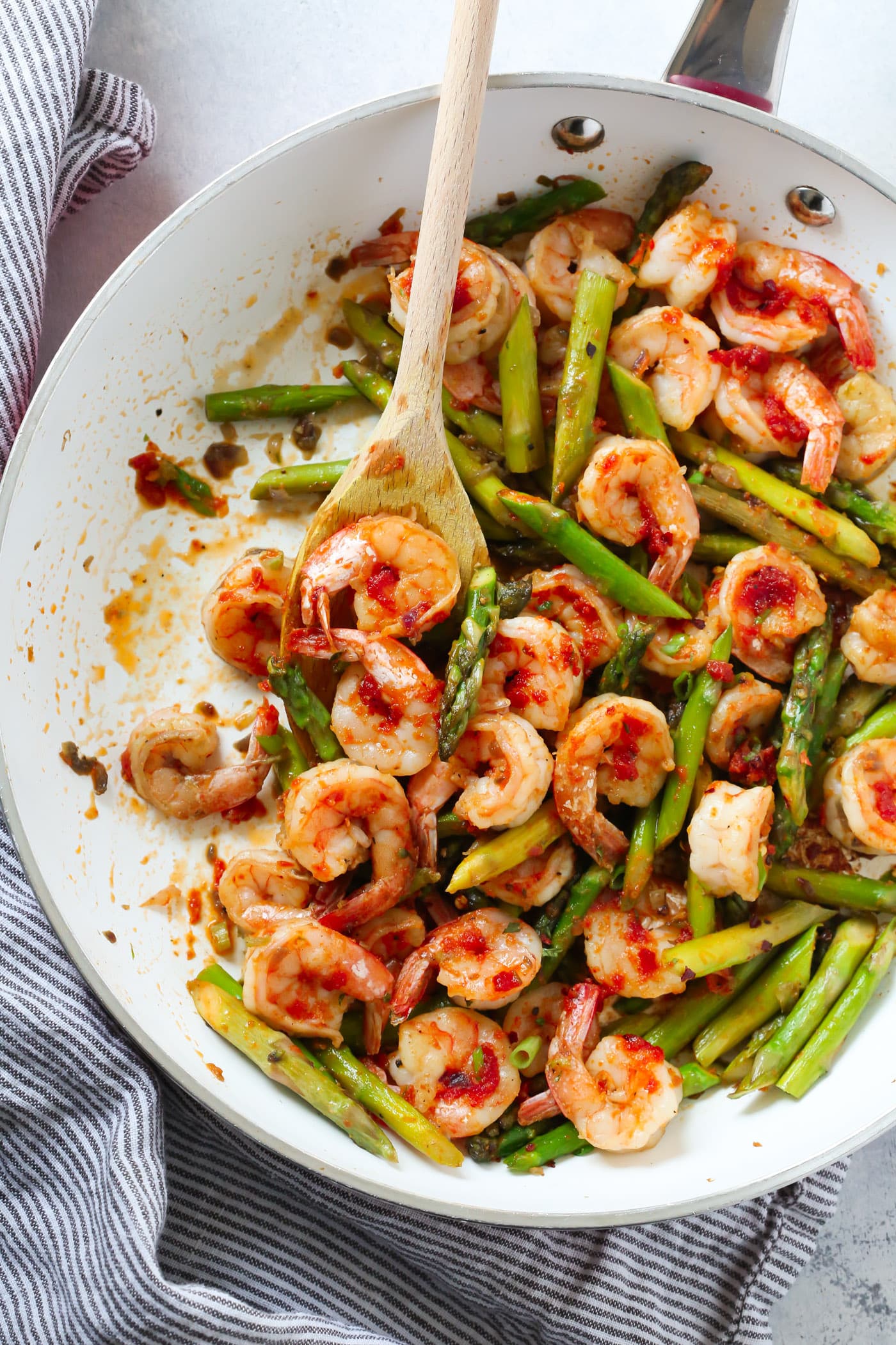 Shrimp Dinner Recipes - White skillet with sun dried tomato and pesto shrimp with asparagus.