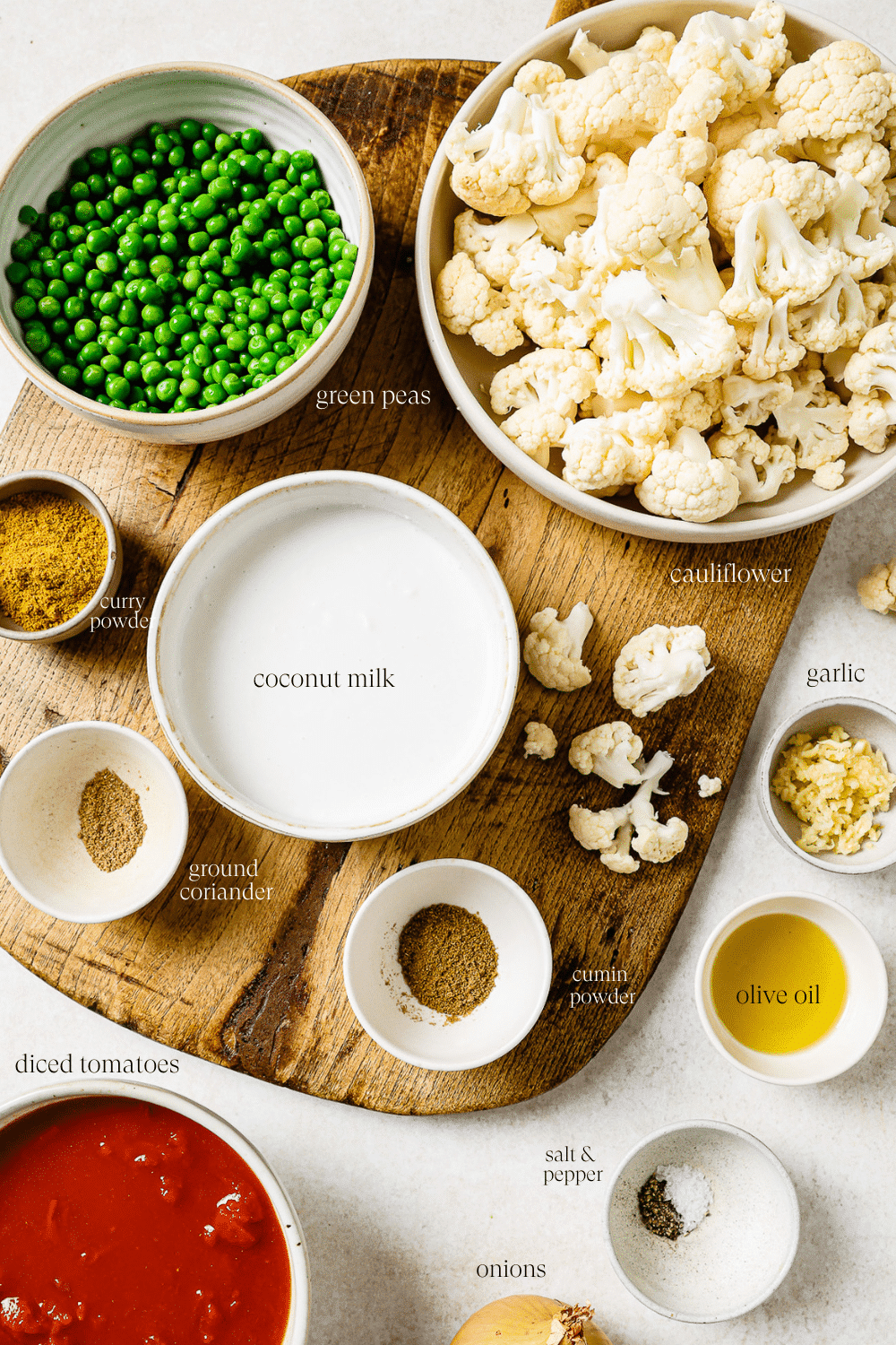 Pre-measured ingredients in small bowls on a wooden cutting board.