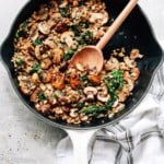 overhead view of a white skillet contains Mushroom Cauliflower Rice