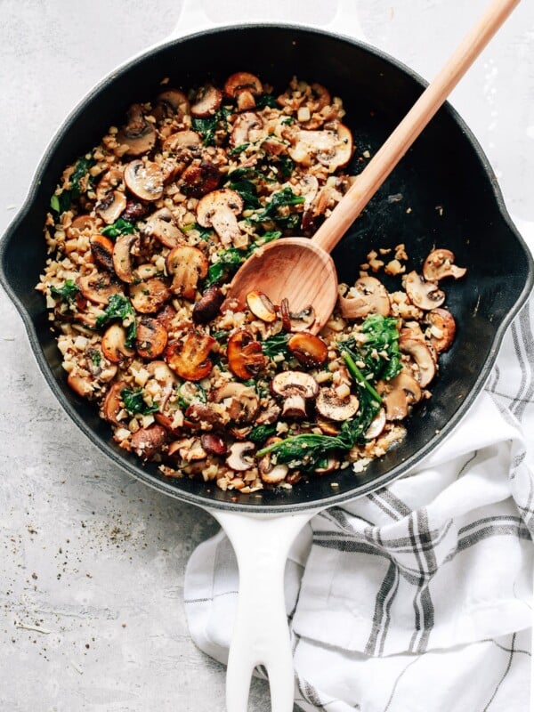 overhead view of a white skillet contains Mushroom Cauliflower Rice