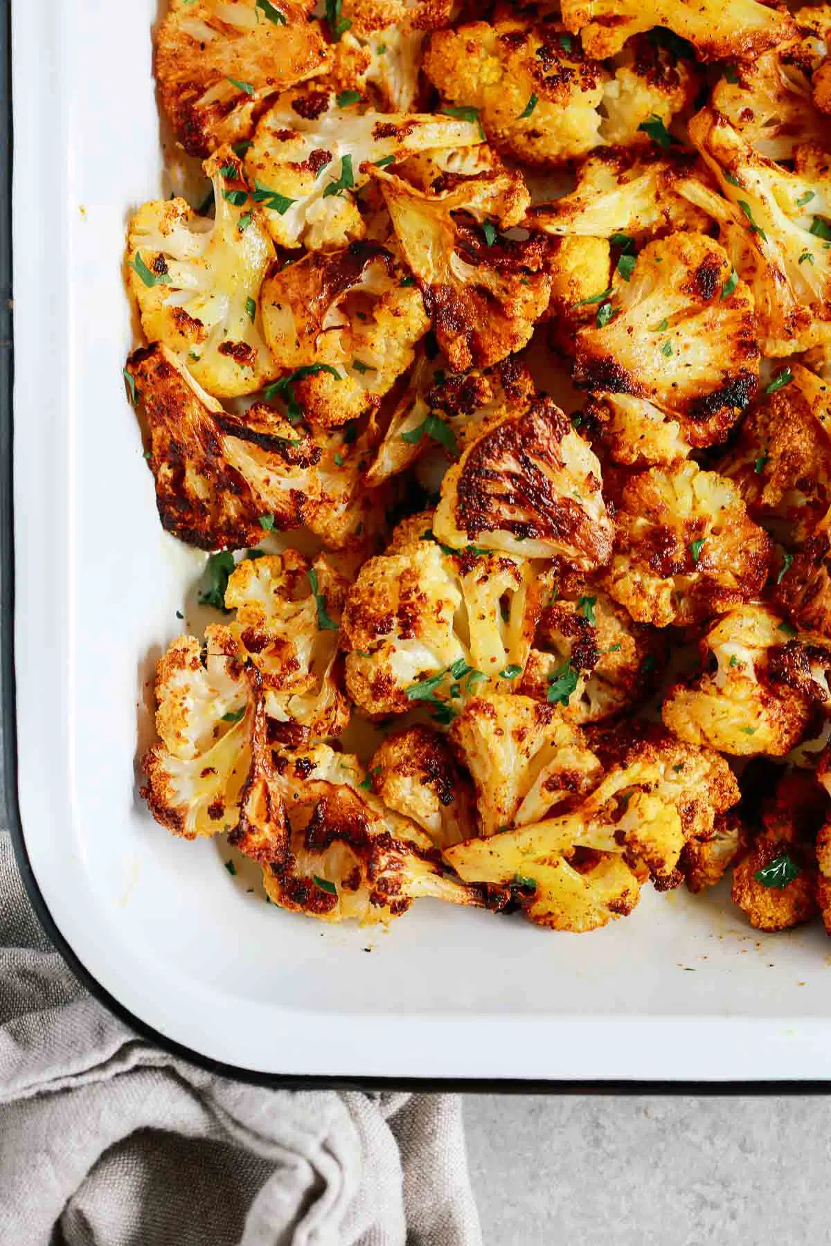 closeup of roasted cauliflower recipe in a white baking sheet