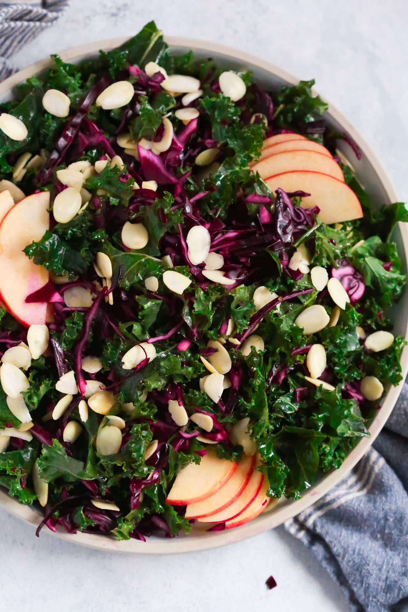 Overhead photo of a large plate of chopped red cabbage kale salad.