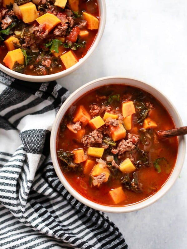 overhead view of two bowls containing Ground Beef Butternut Squash Kale Soup