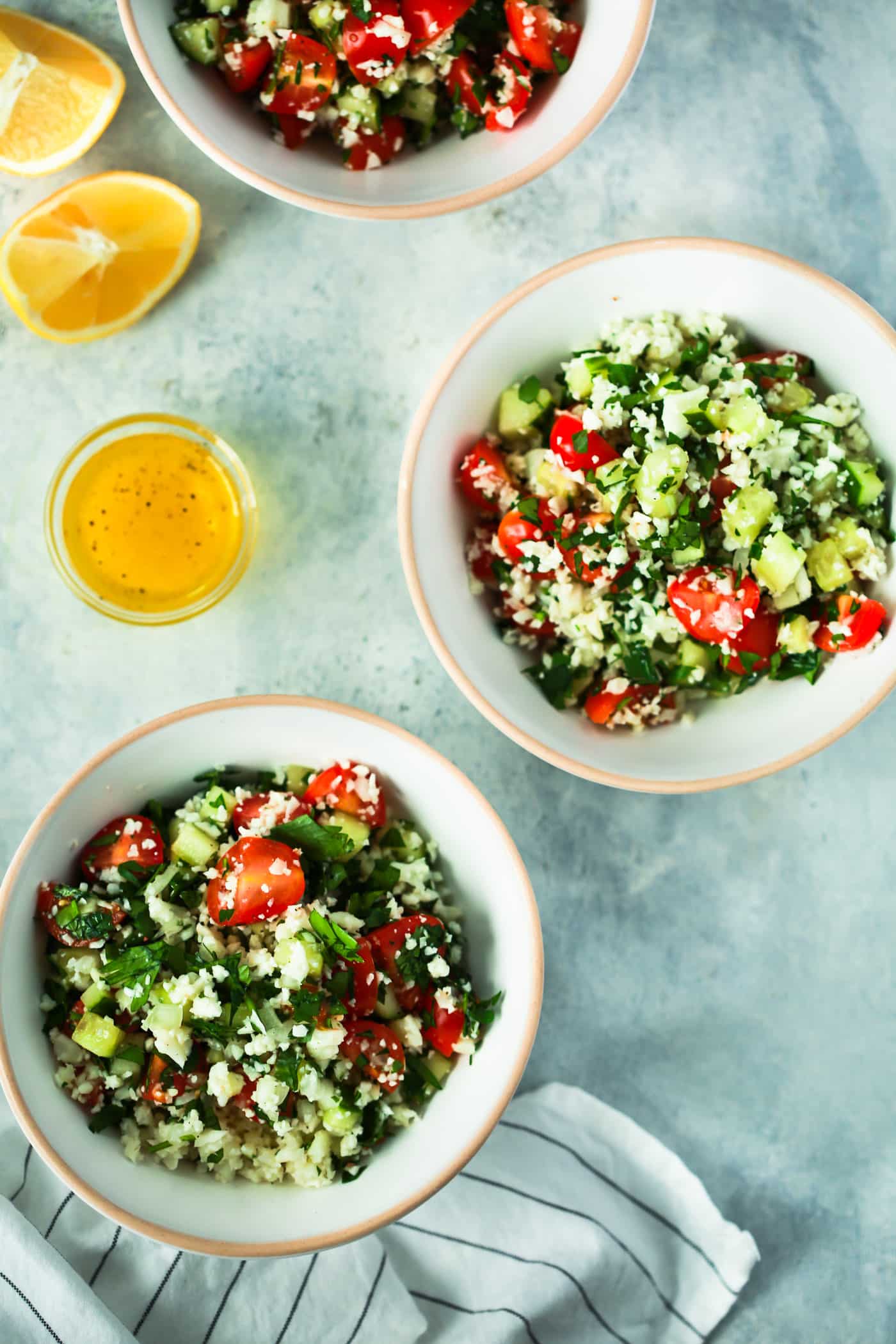 Overhead photo of two bowls of cauliflower rice tabbouleh salad.