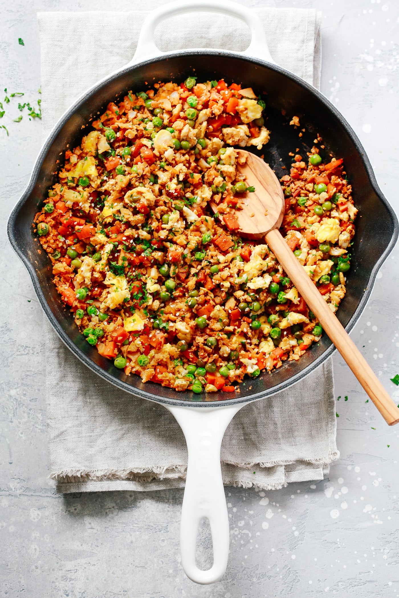 close up of a cast iron skillet containing fried cauliflower rice