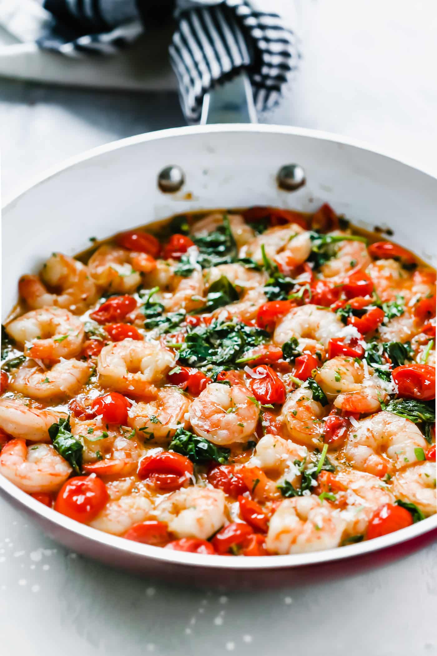 Creamy parmesan shrimp in a skillet.