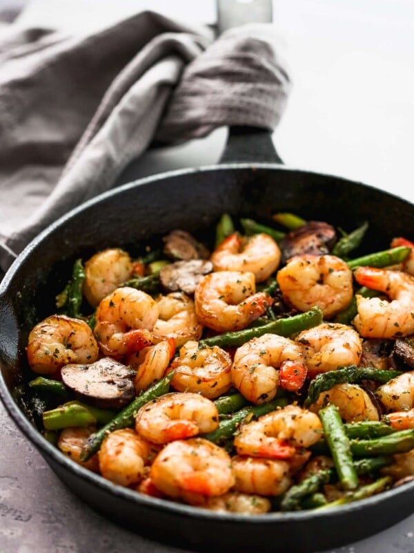 Sauteed shrimp, asparagus and mushrooms in a skillet.