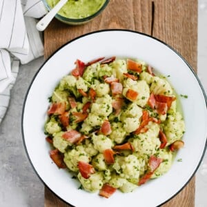 Overhead photo of a white plate of creamy avocado cauliflower salad.